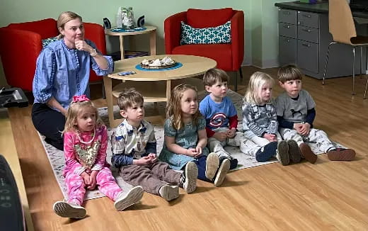 a group of children sitting on the floor