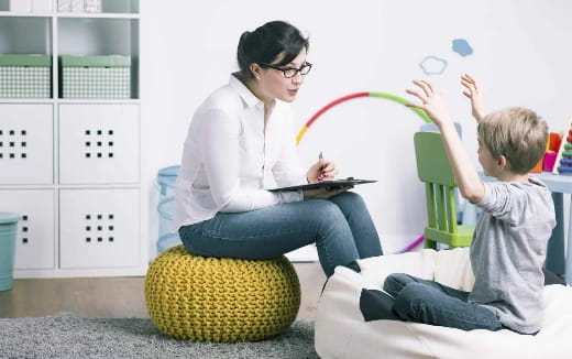 a person and a child sitting on a yellow ball