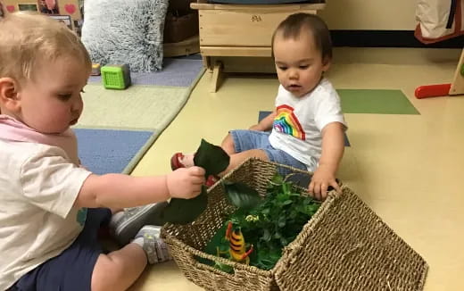 a couple of young boys playing with a toy