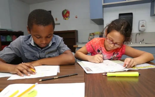 a boy and girl studying