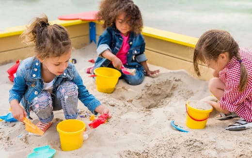 a few children playing in sand