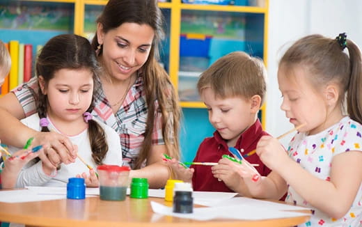 a group of children painting