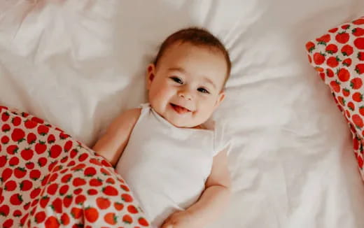 a baby lying on a bed