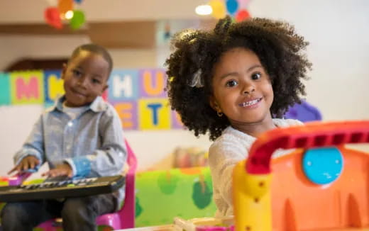 a couple of children playing with a toy