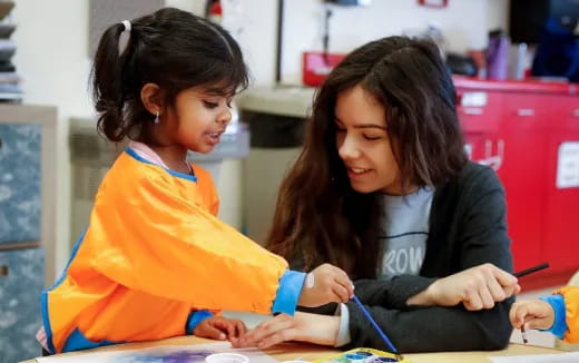 a person and a young girl studying
