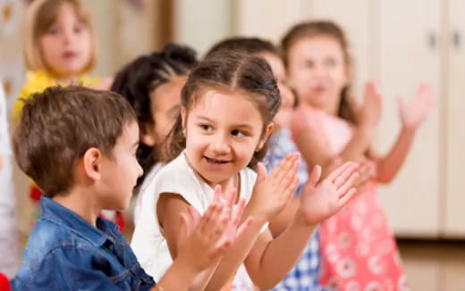 a group of children clapping