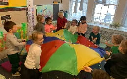 children sitting around a tent