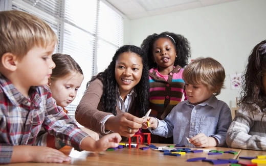 a person and several children playing a game