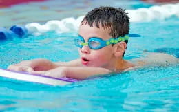 a baby wearing goggles in a pool