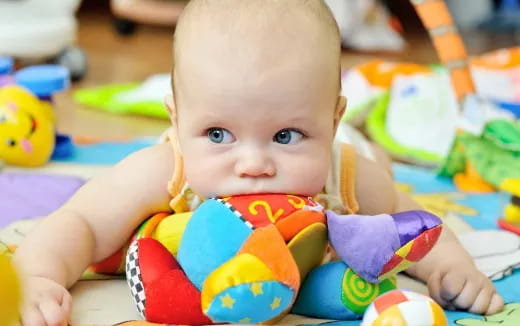 a baby lying on a blanket