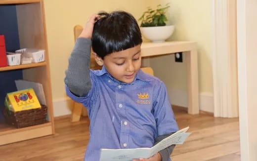 a young boy reading a book