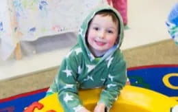 a child in a green jacket