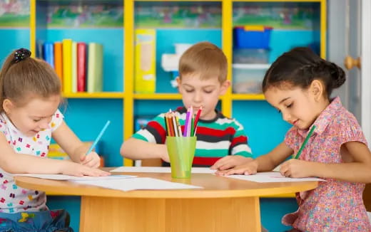 a few children sitting at a table