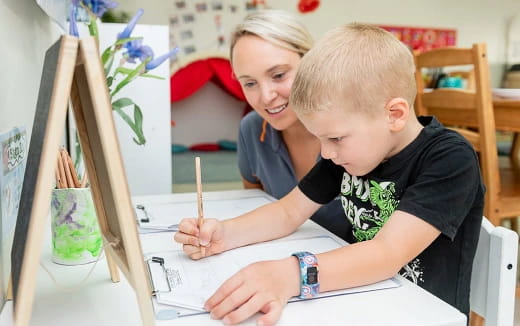 a person and a boy painting