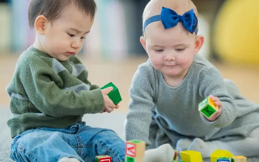 two boys sitting on the ground