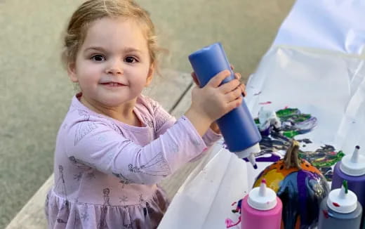 a child holding a brush