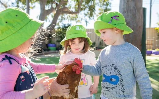 a group of children holding a stuffed animal