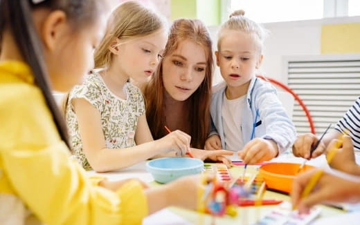 a group of children sitting at a table