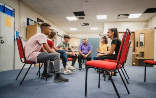 a group of people sitting in chairs