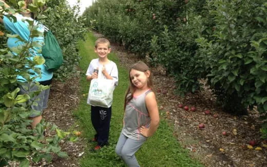 a couple of girls standing in a garden