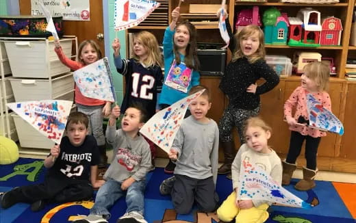 a group of children holding up a flag