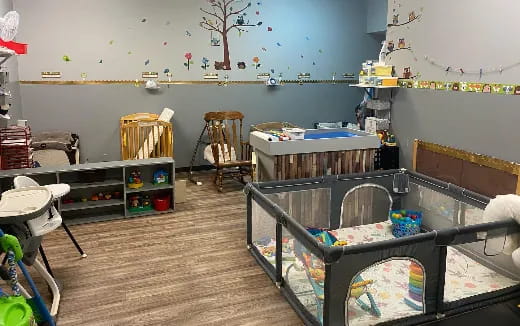 a room with a crib and toys
