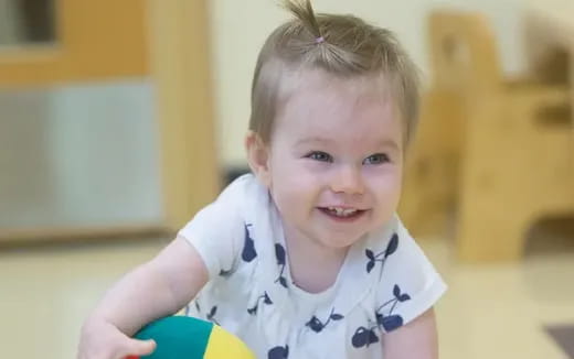 a child holding a ball