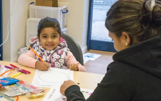 a person and a child sitting at a table