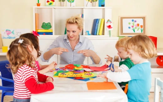 a group of children sitting at a table