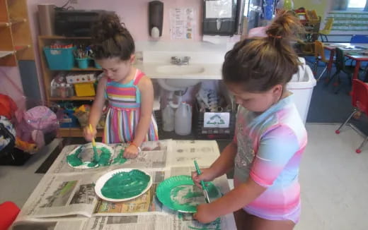 a couple of young girls painting