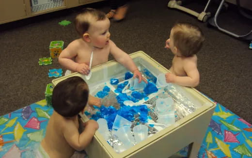 a group of babies playing with toys