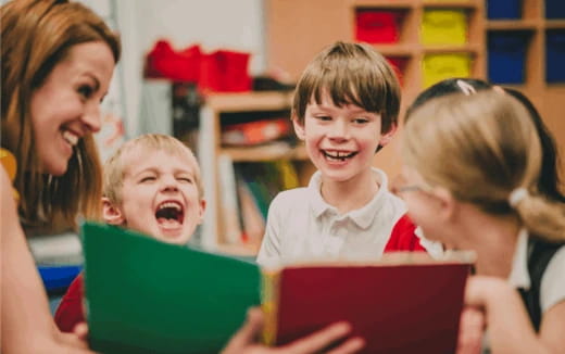a group of children looking at a laptop