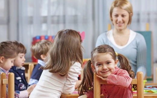 a group of children sitting in a classroom