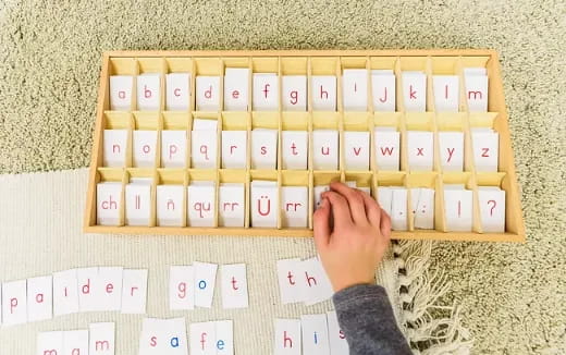 a person's hand on a board with many stickers on it