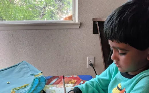 a boy painting on a table