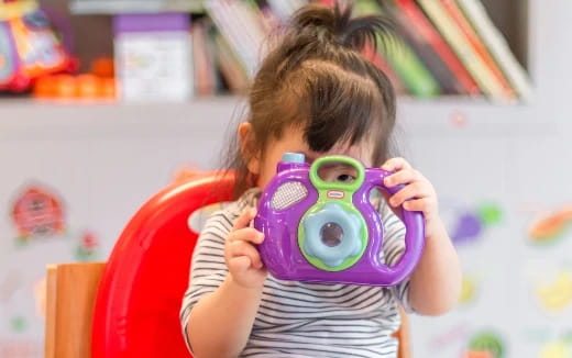 a girl holding a toy