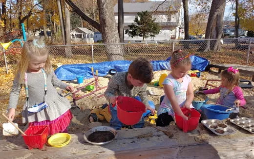 a group of children playing in the sand