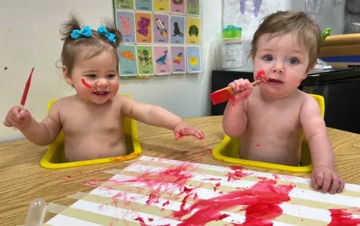 two babies in a yellow tub