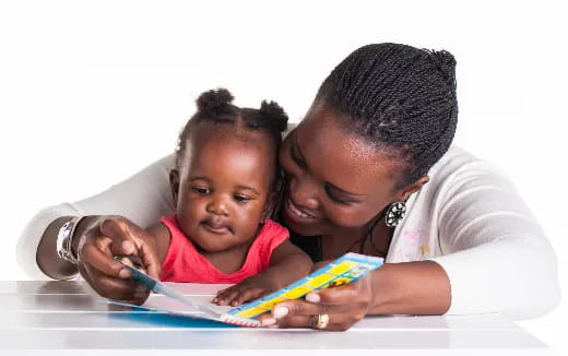 a person and a child looking at a tablet