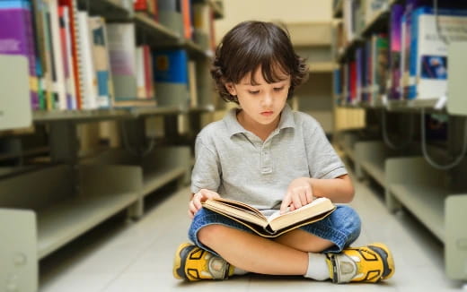 a young boy reading a book