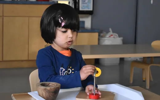 a child painting on a table