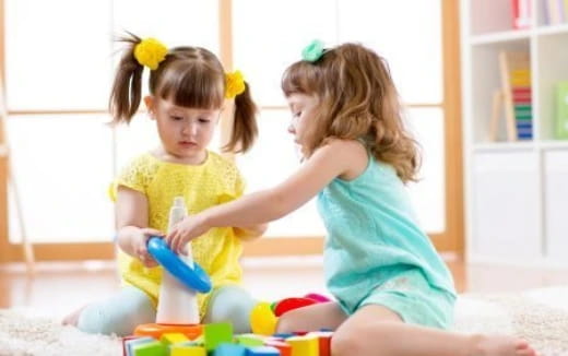a couple of girls playing with toys
