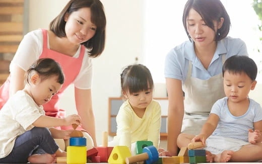 a person and several children playing with toys