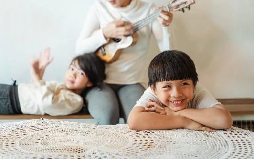 a group of people lying on the floor and holding a guitar