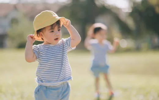 a young boy wearing a yellow hat