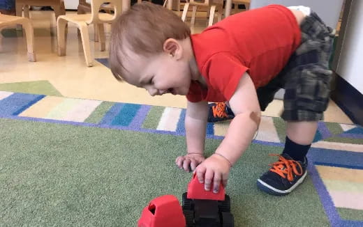 a boy playing with a toy