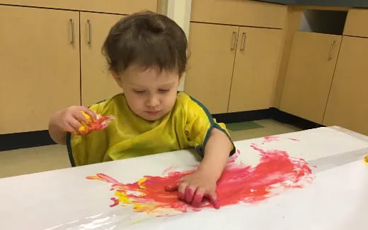 a child painting on a table