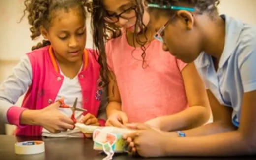 a group of people looking at a paper