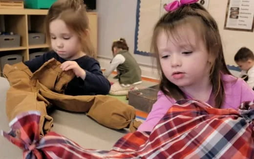 a couple of young girls sitting at a table