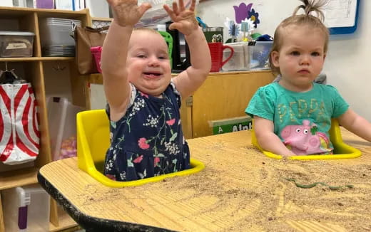 a couple of children sitting at a table